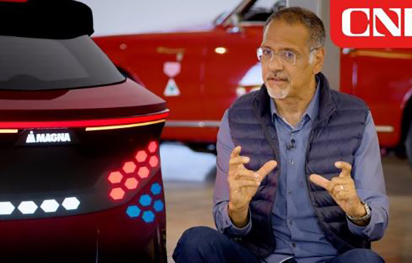 Picture of a person sitting beside a red liftgate with blue, red and white tail lights