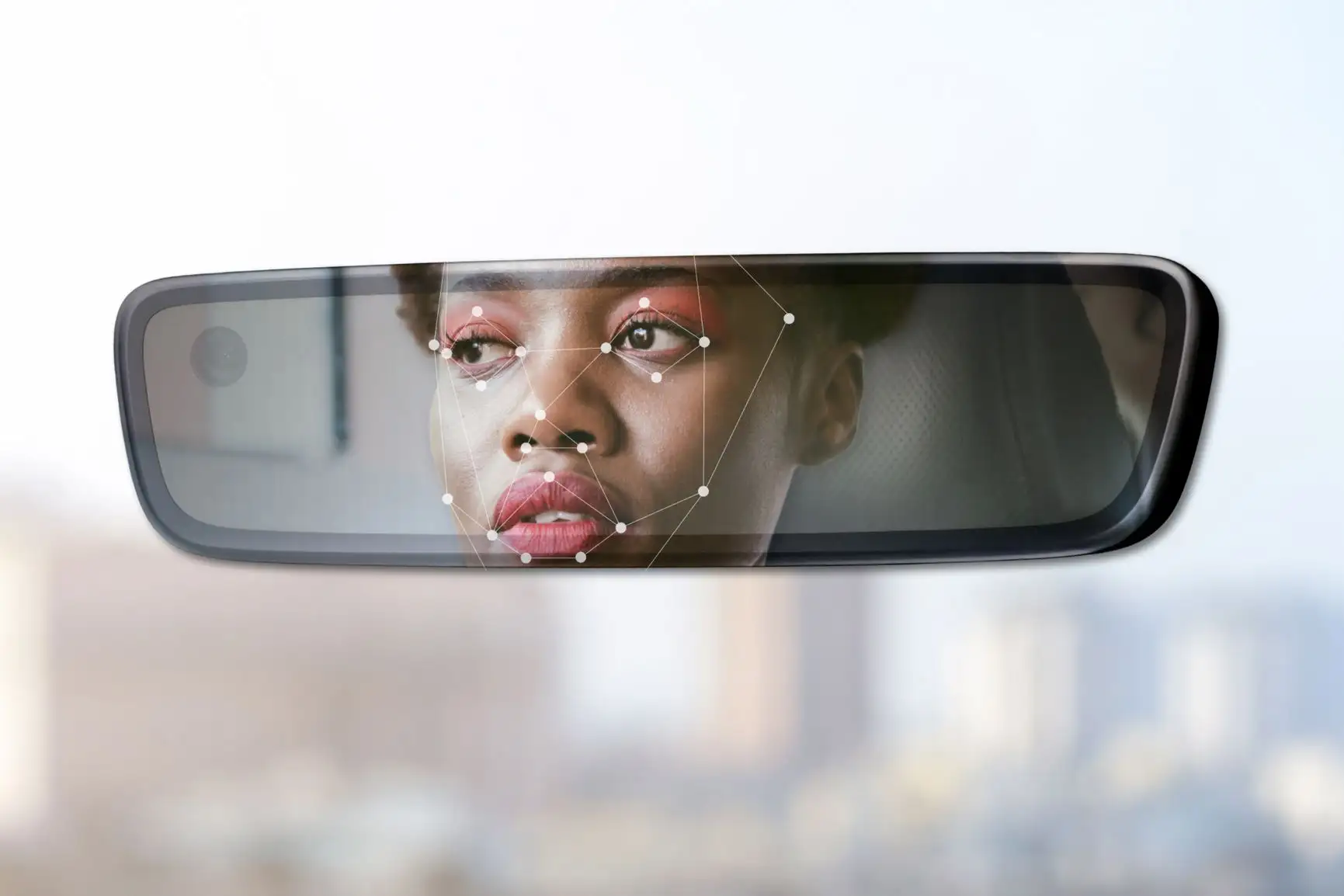 “A car’s rearview mirror displaying a facial recognition system detecting the driver’s face with mapping points