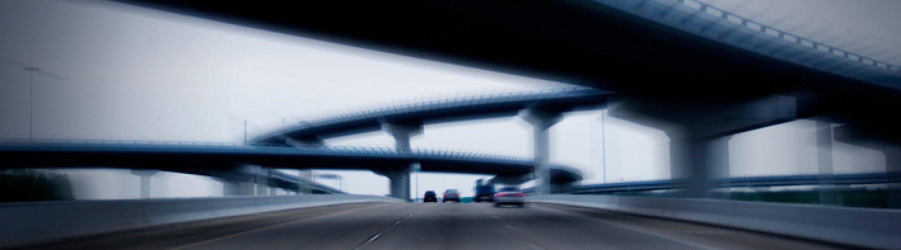 Cars driving on a highway with overpass bridges