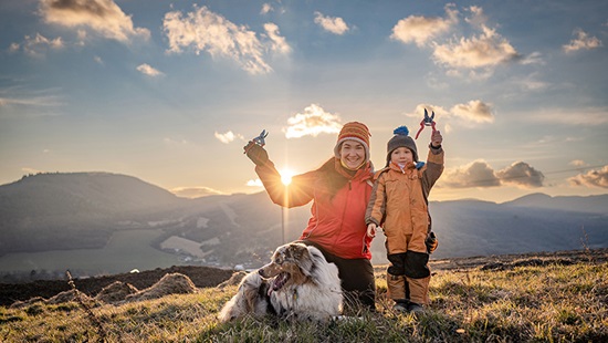 Silvia Viazankova son and dog standing on a hillside