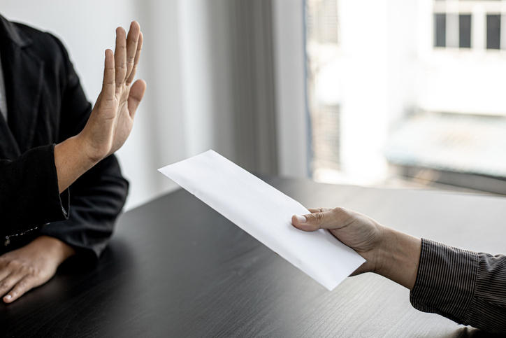 Person rejecting an envelope with a raised hand gesture